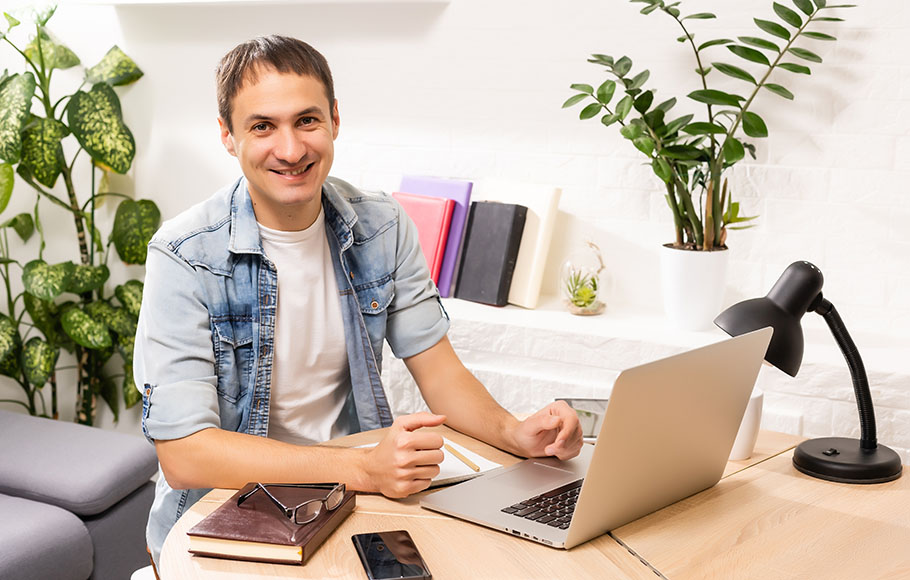 man using laptop working from home